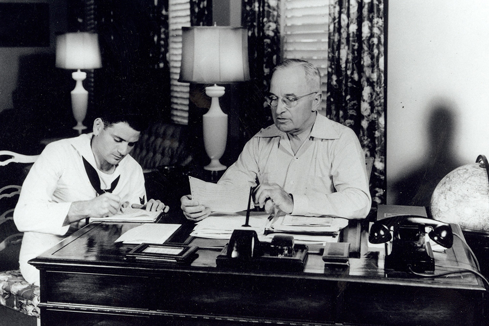 An archival photo of President Harry S. Truman working at the Truman Little White House in Key West, Florida - US Navy/ Truman Little White House Collection