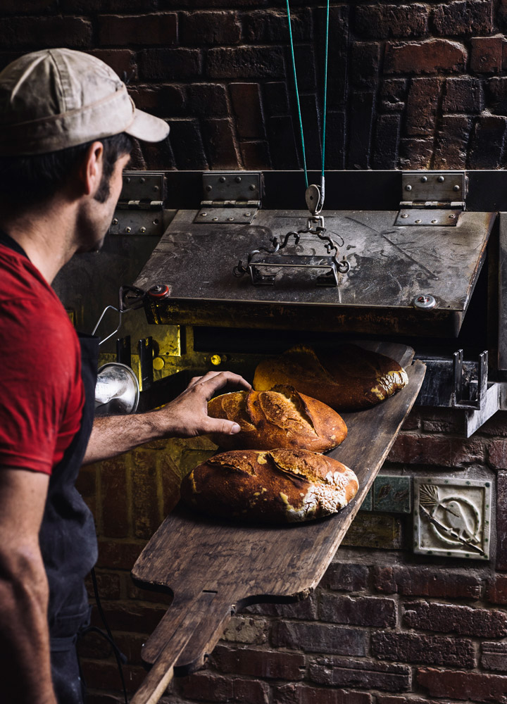 Fresh bread being baked at <em>Farm & Sparrow</em> in Asheville, North Carolina - Johnny Autry