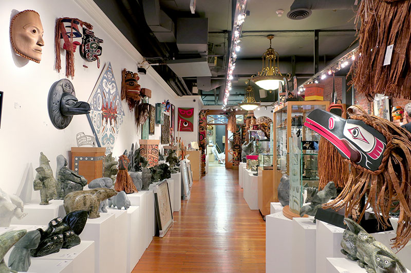 Collection of masks, stone carvings and wall hangings at Coastal Peoples gallery - Photo by Hideaway Report editor