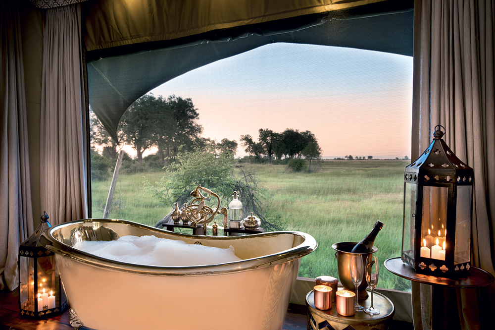 The view from the tub in a guest tent at Duba Plains Camp in Duba Plains Reserve, Botswana - DOOKPHOTO