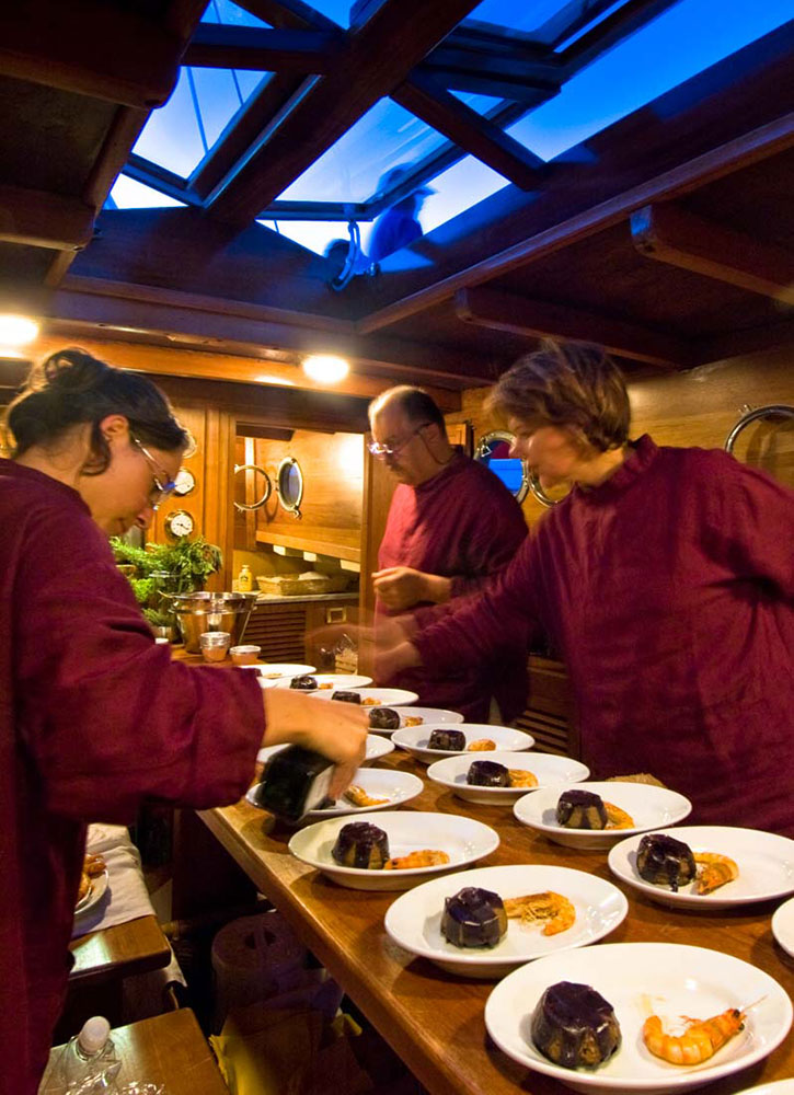 Stoppa's staff prepping dishes in the boat’s kitchen on the Venetian Lagoon in Italy - Paolo Spigariol