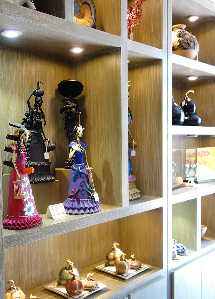 Day of the Dead-inspired wood carvings sit on the shelves of Sortilegio in the San Angel neighborhood of Mexico City, Mexico - Photo by Hideaway Report editor